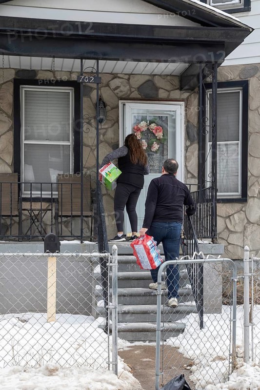 Detroit, Michigan - Detroit, Michigan - Workers from the Detroit Hispanic Development Corporation deliver diapers, water, and other supplies to families dealing with the flooding from a major water main break in southwest Detroit. The broken pipeline affected hundreds of homes