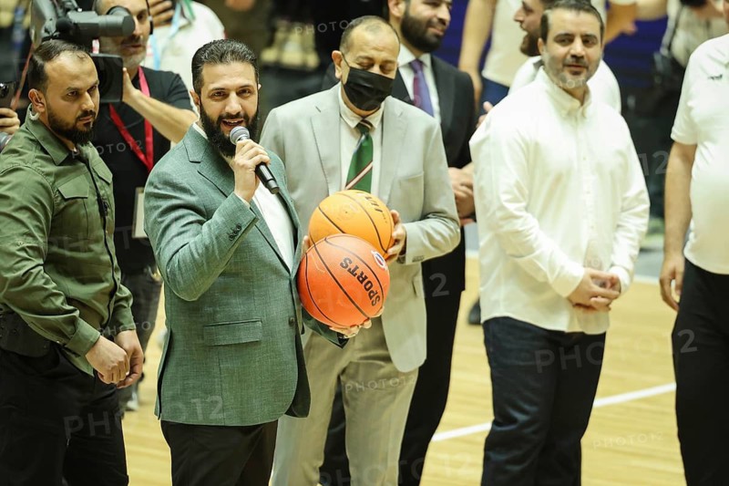 Syrian President Ahmad Al-Sharaa holds a basketball on the court during the official reopening ceremony of the newly renovated Al-Fayhaa Sports Hall. The event was marked by a friendly basketball match between the national teams of Syria and Lebanon, highlighting the country's ongoing efforts in post-war reconstruction and the rehabilitation of its sports infrastructure in Damascus, Syria on April 20, 2026, Damascus, Syria
