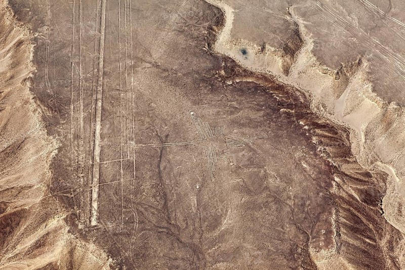 Lines visible from the air and a cross pattern on a dry, hilly sandy area, the geoglyphs and images in the desert near Nasca and Palpa in Peru