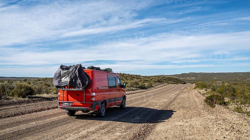4x4 campervan drives along the road near Estancia la Maciega, Chubut, Argentina