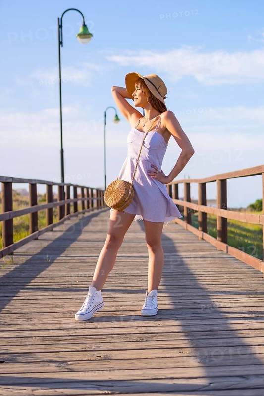Portrait of caucasian brunette woman on the beach in summer vacation