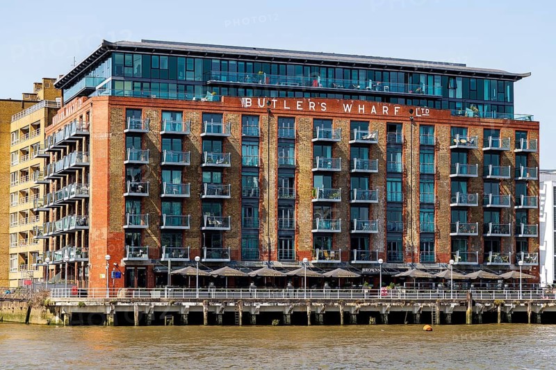 The converted Victorian Butler's Wharf warehouse with its riverside apartments and terrace restaurants on the South Bank, London, England, United Kingdom