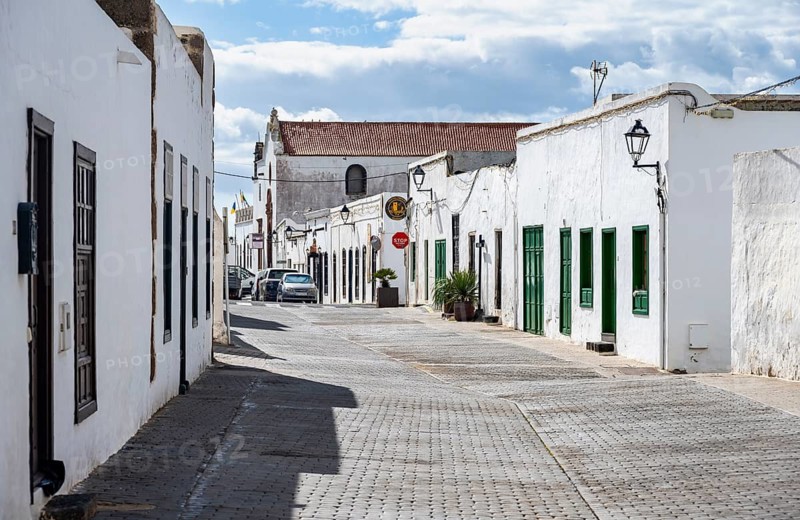 Typical white houses with colored doors and windows in an alley, Teguise, Lanzarote, Canary Islands, Spain