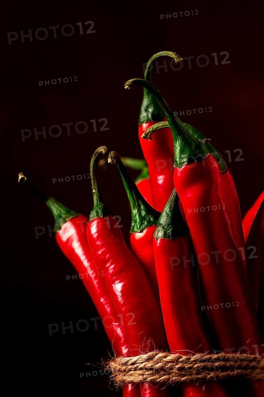 Bunch of red hot chili pepper, close-up, on a dark background, selective focus, no people, concept, food background, toned image