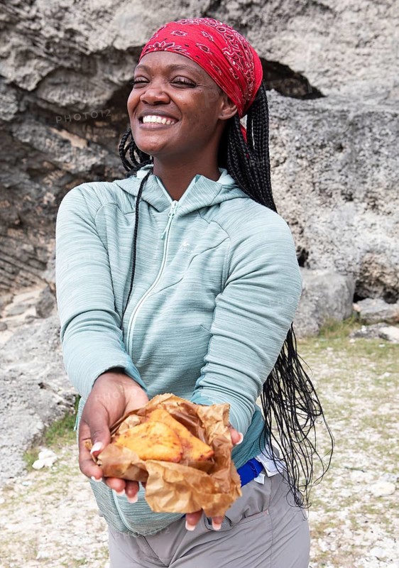 Mauritian woman, 35 years old, showing samoussas or fried dumplings, Rodrigues Island, Mauritius