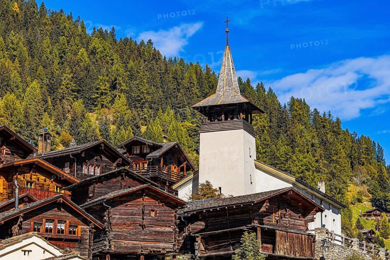 Old wooden houses and the Saint Theodule church in the historic village centre, Grimentz, Val d'Anniviers, Valais Alps, Canton Valais, Switzerland
