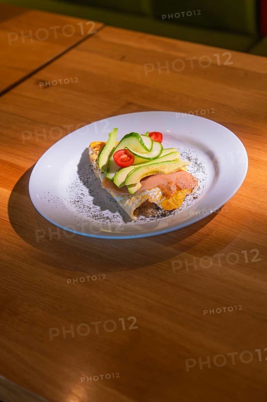 An upscale starter with salmon, avocado and tomatoes served decoratively on a plate, Café Kuh, Deckenpfronn, Germany