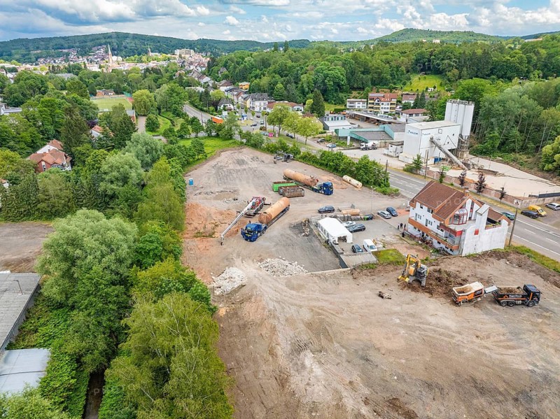 Aerial view of a construction site in the middle of a green landscape and close to buildings, demolition site, recycling, Saarbrücken, Germany