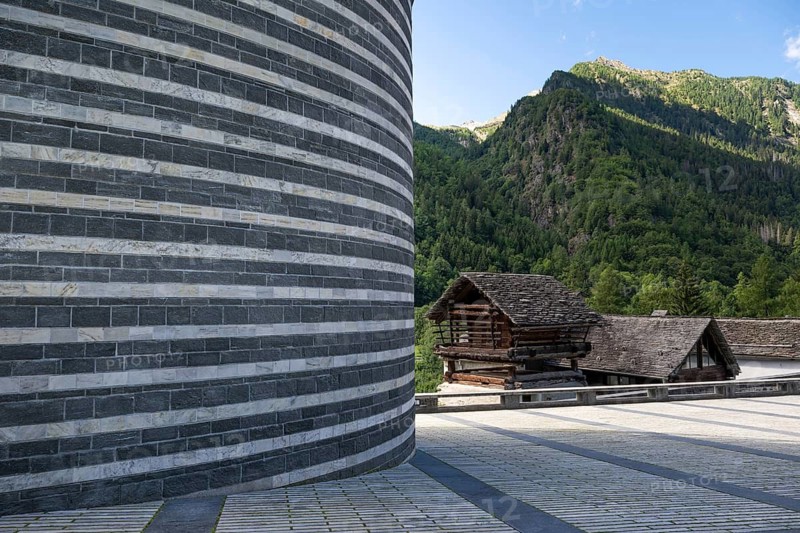 Old granary or torba and detail, outer wall Roman Catholic church of San Giovanni Battista, built on the same site as the village church destroyed by avalanche in 1986, architect Mario Botta, Mogno, Maggia Valley, Valle Maggia, municipality of Lavizzara, Canton of Tessin, Switzerland