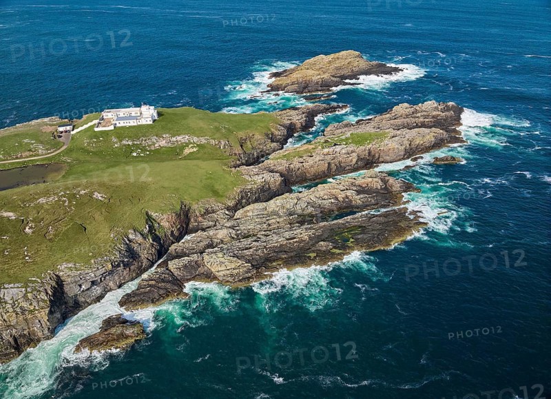 Aerial drone photo of Iighthouse on the rocky cliffs and heavy atlantic ocean surf, Strathy point, northern Scotland, UK