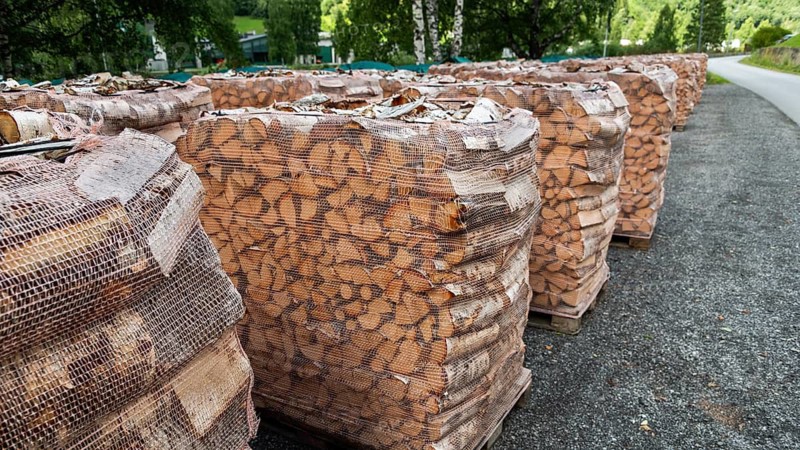Large piles of firewood covered with nets, birch wood, Otta, Sel Municipality, Upper Gudbrandsdal, Norway