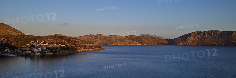 Wide sea area with coastline in morning sunlight, Symi town, Symi, Dodecanese, Greek Islands, Greece