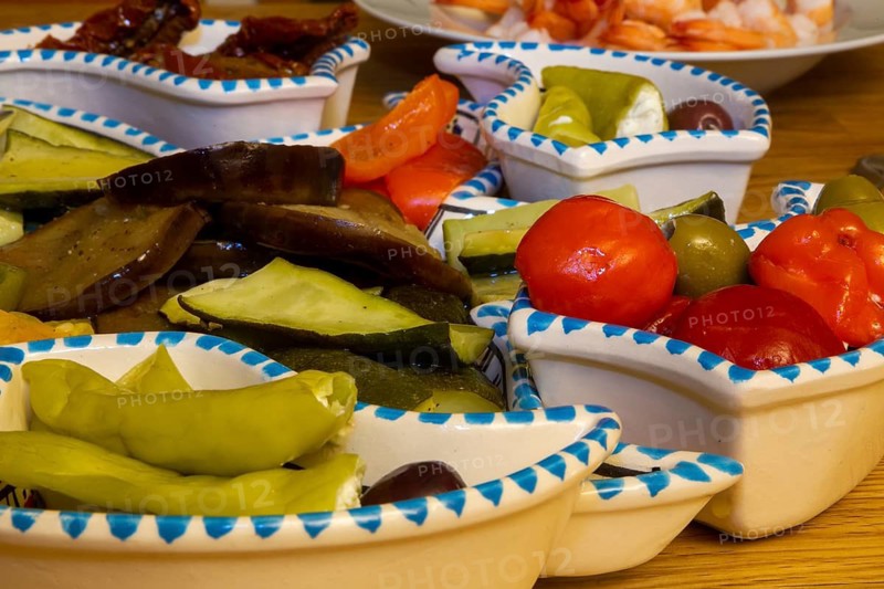 Antipasti with peppers, olives, courgettes, peppers and tomatoes