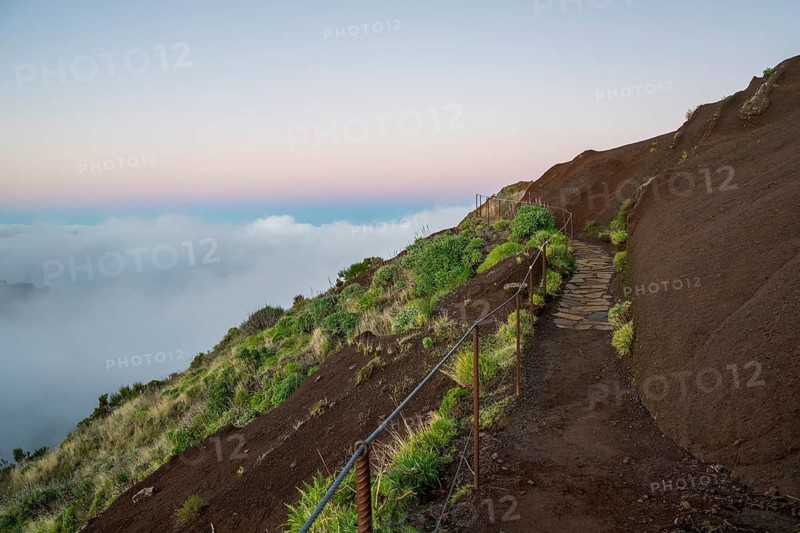 Sunrise at Pico do Arieiro, clouds of fog sweep over mountain peaks, sea of fog, hiking trail PR1, Madeira, Portugal