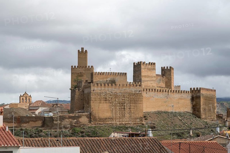 View over rooftops to the Alcazaba of Guadix, Granada, Spain