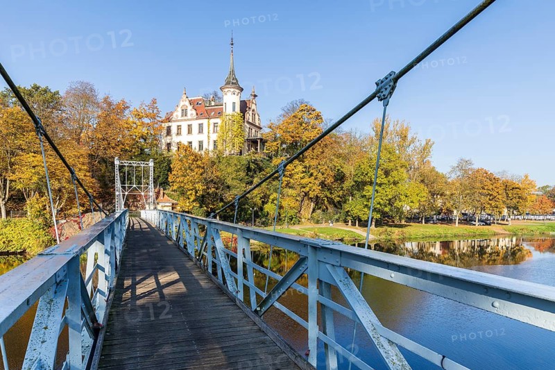 Gattersburg and suspension bridge over the Mulde in autumn, Grimma, Saxony, Germany