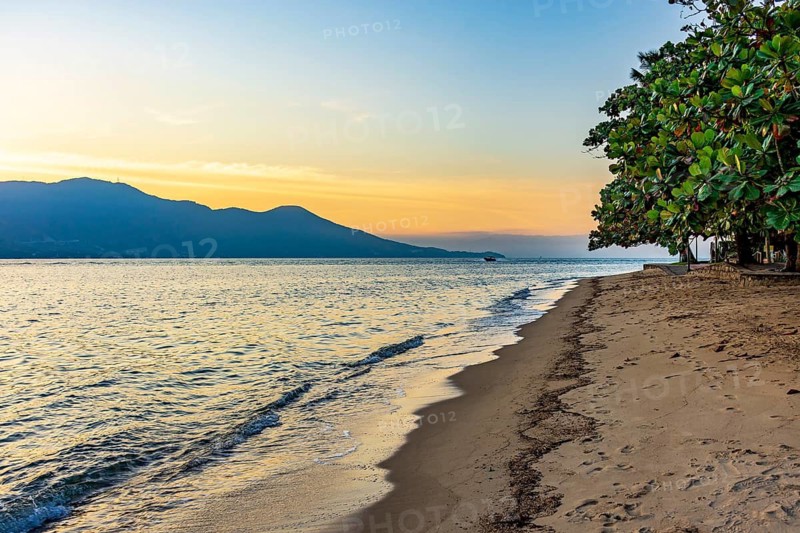 Beach in the urban area of ??Ilhabela island during sunset, Ilhabela, Sao Paulo, Brazil