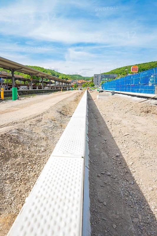 Straight view of construction work on the station area under a blue sky, Leonhard Weiss construction site for the renovation of the station and construction of the overhead line, Waldshut, Germany