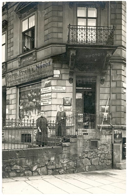 Chemnitz, Zschopauer Str., Hermann Preiß descendants, plumber, shop, business, profession, twenties, a child and a woman standing in front of a shop with several advertising signs and a fence, around 1924