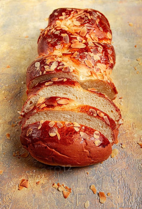 Braided, sweet bread pie, with sliced almonds, breakfast, braided bread, brioche, on a light background, top view, no people