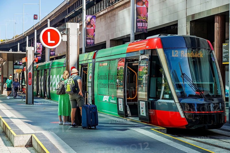 Passengers wait on the platform for an L2 Randwick light rail tram at Circular Quay, Sydney, Australia