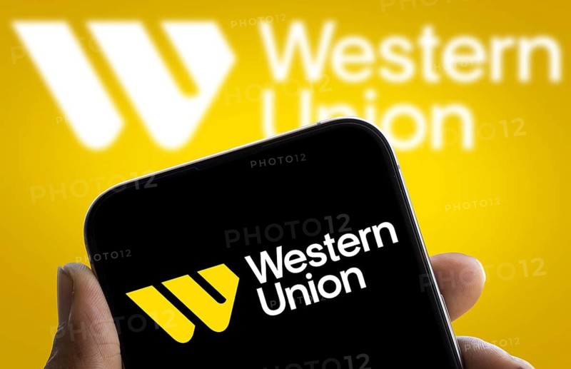 Western union logo is displayed on smartphone. The Western Union Company is an American multinational financial services corporation