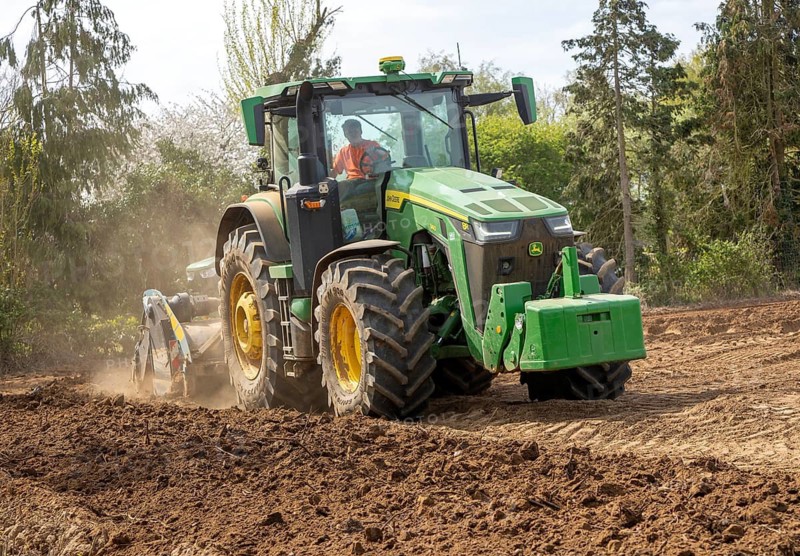 John Deere 8R 340 tractor engaged in field work operating an Agri-World FTC series soil tiller, Shottisham, Suffolk, England, UK