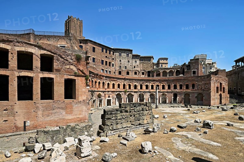 View of historic Traian's Forum Forum of Traian Foro Traiano from antiquity with building in semicircle at the back with colonnade in the foreground forecourt open space with column fragments remains of marble columns, Rome, Lazio, Italy