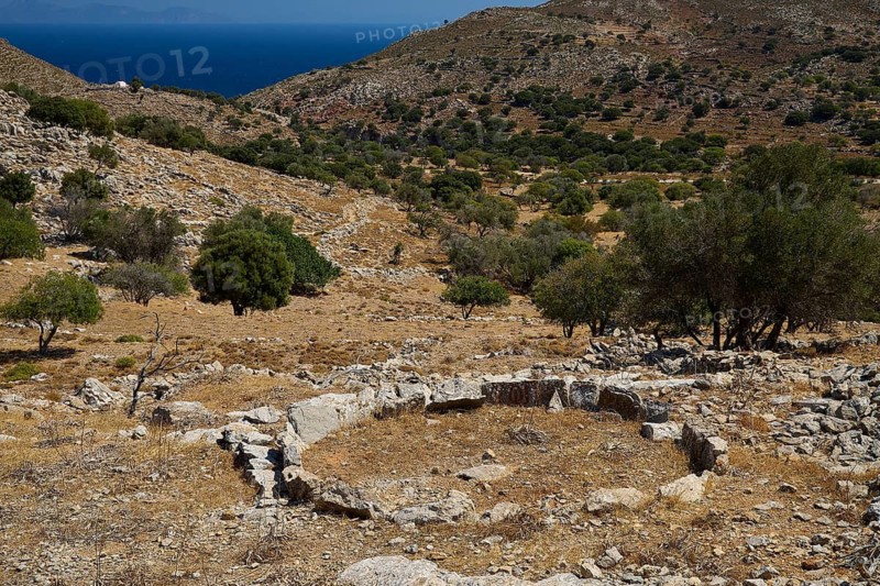 Dry, hilly landscape with ancient ruins and trees, sea view in the background, Lost Place, Abandoned Village, Micro Chorio, Church of the Assumption of Mary, Zero Waste Island, Tilos, Dodecanese, Greek Islands, Greece