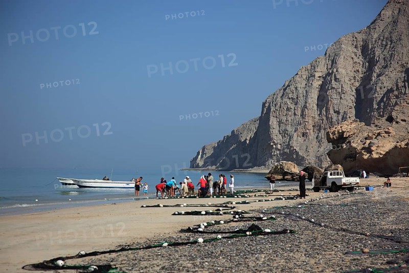 Fishermen in the coastal landscape of Bukha on the Arabian Gulf, in the Omani enclave of Musandam, Oman