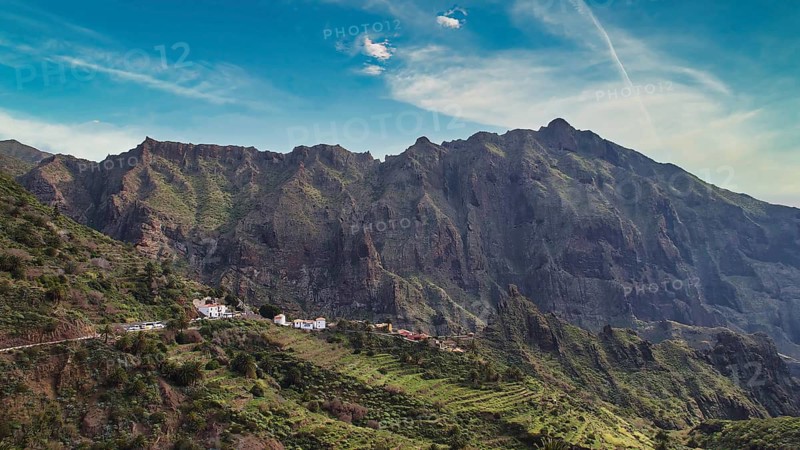 Impressive mountain range with green vegetation and small village in the foreground, Masca, Barranco de Masca, canyon, Teno Mountains, northwestern Tenerife, Tenerife, Canary Islands, Spain