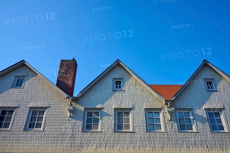 House with white wood paneling, several gables and chimney under clear blue sky, Erbach, Odenwald, Hesse, Germany