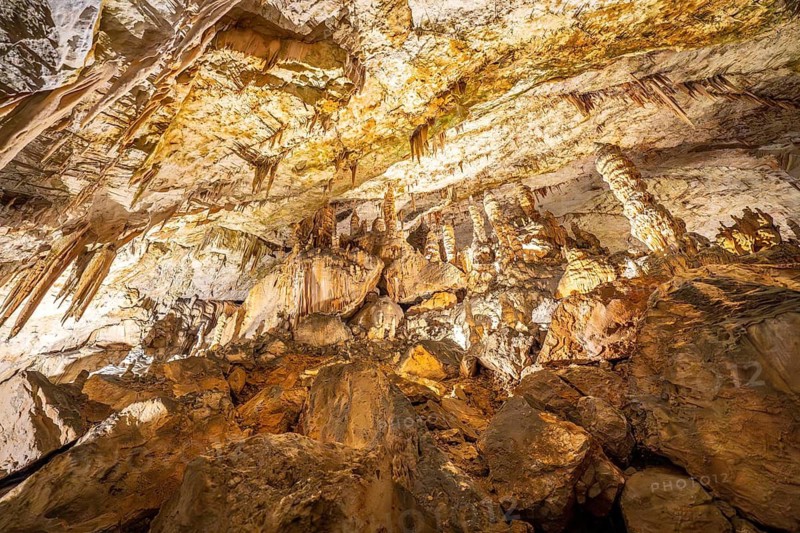 Breathtaking view of illuminated stalactites and stalagmites formations inside postojna cave, a famous tourist attraction in slovenia