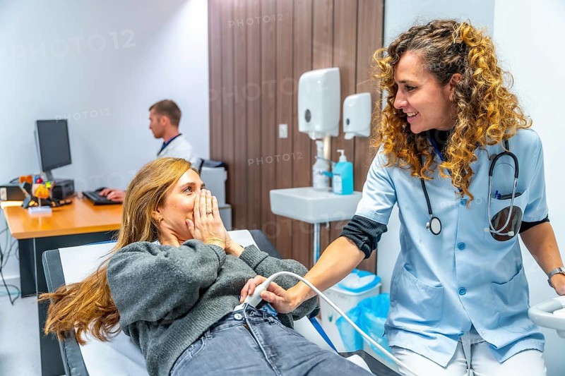 Female doctor informing a patient that she is pregnant during an ultrasound