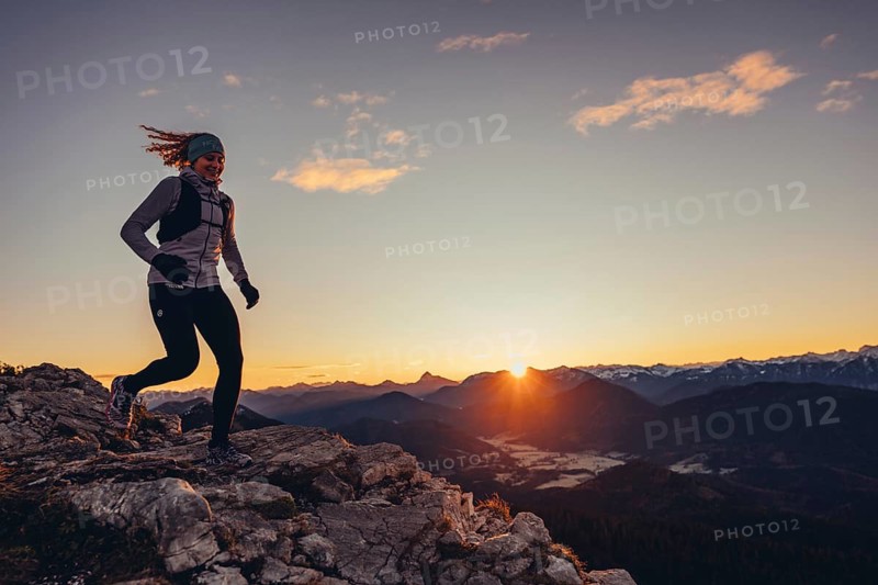 Trail running in autumn on the Jochberg on Lake Walchensee against the wonderful backdrop of the Alps, Bavaria, Germany