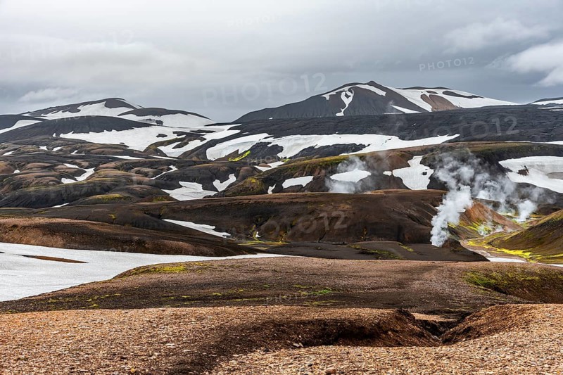 Colourful volcanic landscape with hills and snow, volcanic steaming hot springs, Laugavegur trekking trail, Landmannalaugar, Fjallabak Nature Reserve, Icelandic Highlands, Suðurland, Iceland