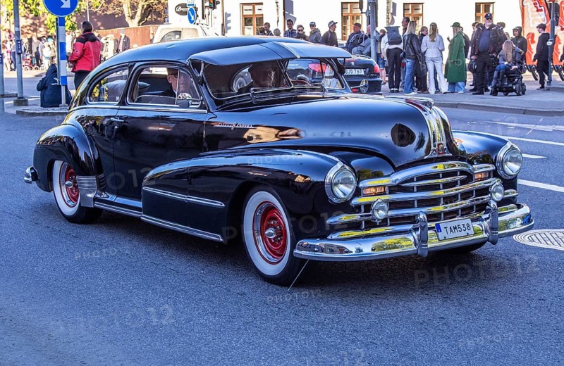 Pontiac Silver Streak 1948 oldtimer at traditional cruising with many older American cars in Ystad, Skåne County, Sweden, Scandinavia