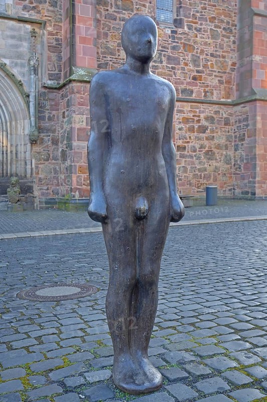 Sculpture Out of the dark by Antony Gormley 1987, dark black naked male figure, darkness, dark, smooth bronze sculpture, standing, St Martin's Church, Kassel, Hesse, Germany