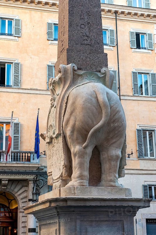 Elephant designed by Gian Lorenzo Bernini commissioned by Ercole Ferrata turns showing rear end popo arse to church portal entrance facade of church basilica Santa Maria sopra Minerva, Piazza della Minerva, Rome, Italy