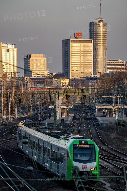 S-Bahn train on the tracks west of Essen main station, skyline of the city centre, North Rhine-Westphalia, Germany
