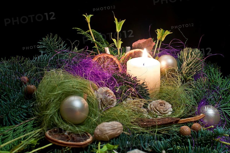 Christmas floral decoration with candle.