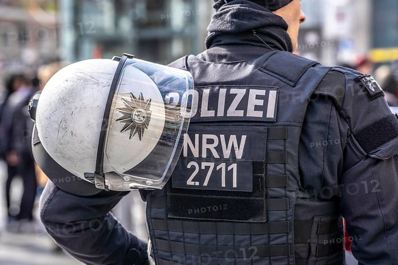 Police officers of a riot squad, riot police, with helmet and riot suit at a left-right demonstration in Essen, North Rhine-Westphalia, Germany