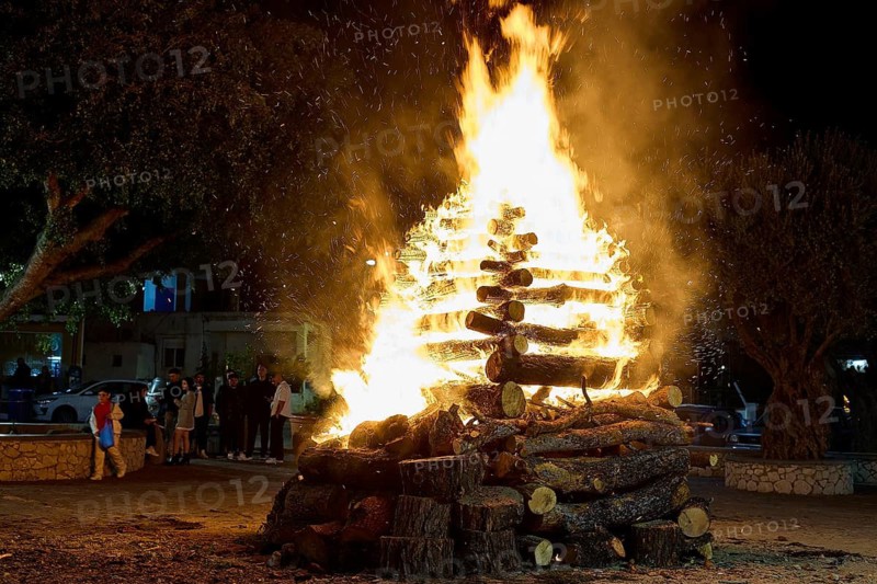 ©Udo Rein, A large pile of wood in flames is watched by a group of people at night, Easter fire Psinthos, Holy Saturday, Easter, Psinthos, Rhodes, Dodecanese, Greek Islands, Greece
