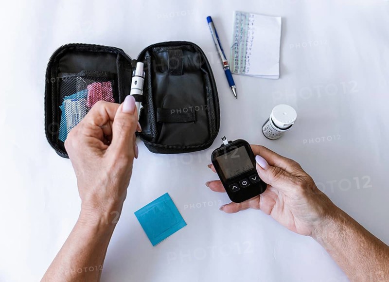 Female hand holding digital blood glucose meter after measuring blood sugar. Diabetes management, endocrinology, healthcare technology, home testing, prevention and chronic disease monitoring concept