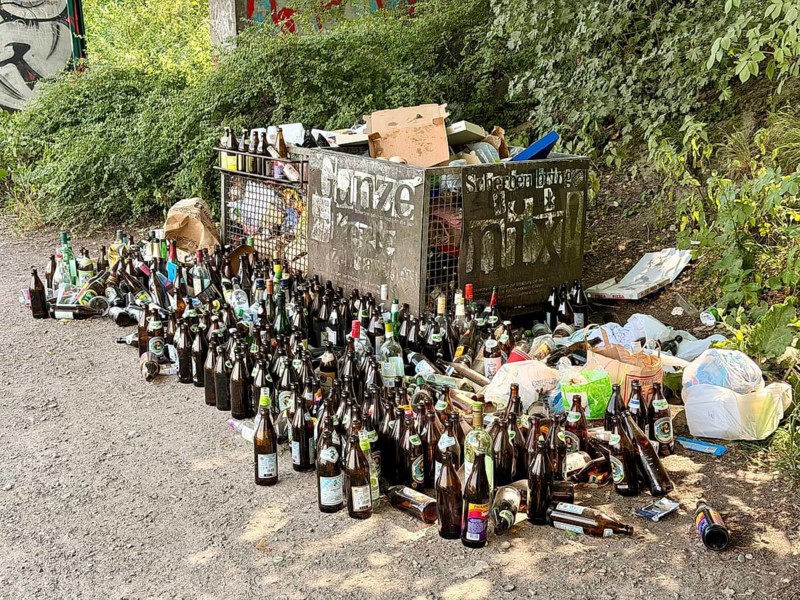 Lots of empty bottles and trash on the Isar, Munich, Germany
