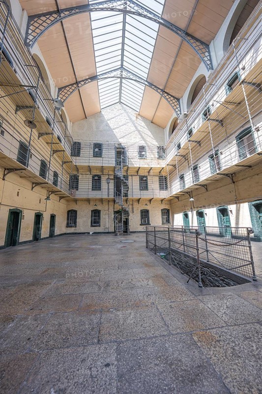 Large courtyard with glass roof and surrounding galleries in a historic building, Kilmainham Gaol Prison, Dublin, Ireland