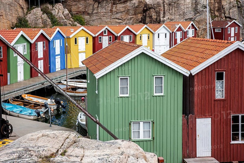 Small colourful houses by the sea. Typical houses in Sweden for the coastal landscape. Crab fishing and storage in a narrow harbour. Smögen, Smögenbryggan, Sweden