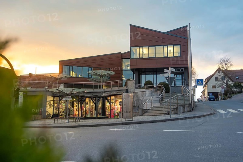 Modern town hall in the city at sunset, quiet street in the foreground, Gechingen, Calw district, Germany