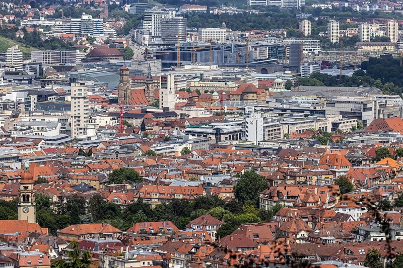 City view of Stuttgart. View of the city centre with the central sights such as the collegiate church, town hall tower, Schlossplatz, main railway station and New Palace. Stuttgart, Baden-Württemberg, Germany