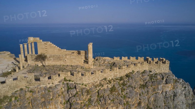 Drone shot, Acropolis of Lindos, Late afternoon light, Temple of Athena Lindia, Ruins of an ancient building on a cliff overlooking the sea, Archaeological site, Lindos, Rhodes, Dodecanese, Greek Islands, Greece